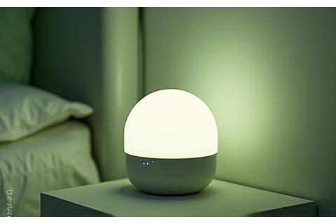 A minimalist white noise machine emitting a soft glow.